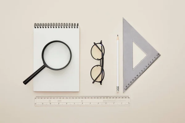 Top View Magnifier Notebook Glasses Rulers Isolated Beige — Stock Photo, Image