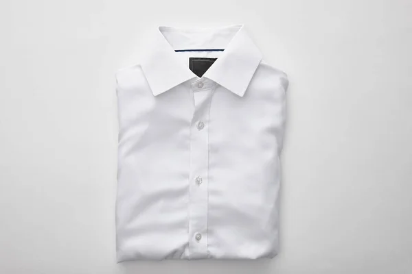 Beyaz Arka Plan Üzerinde Düz Katlanmış Gömlek Üst Görünümü — Stok fotoğraf