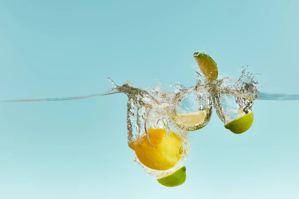 Ripe Lemon Cut Lime Falling Deep Water Splash Blue Background — Stock Photo, Image