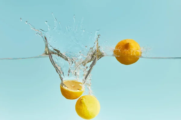 Fresh Ripe Lemons Falling Deep Water Splash Blue Background — Stock Photo, Image