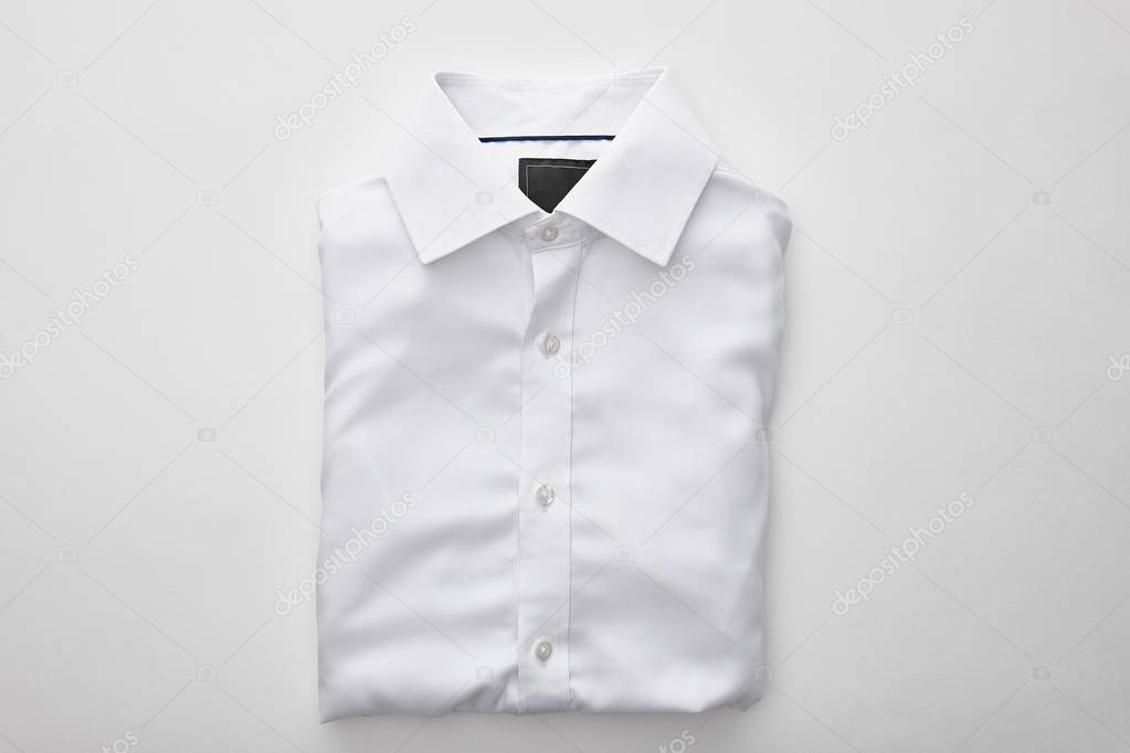 top view of plain folded shirt on white background