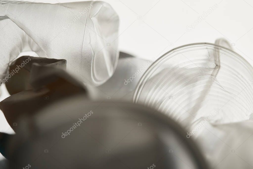 close up view of crumpled plastic rubbish with shadow on white background
