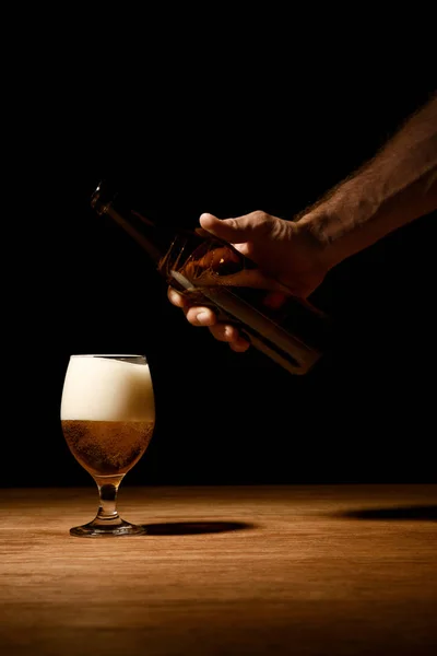 Cropped View Man Holding Bottle Glass Beer Foam Wooden Table — Stock Photo, Image