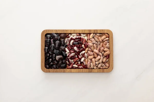 Top View Rectangular Wooden Dish Raw Beans White Marble Surface — Stock Photo, Image