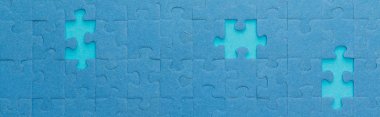 panoramic shot of blue jigsaw puzzle with lighter gaps clipart