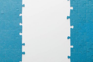 top view of blue jigsaw puzzle on white background clipart