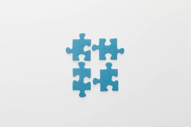 top view of pieces of blue jigsaw puzzle on white background clipart