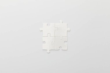 top view of completed part of jigsaw puzzle on white background clipart