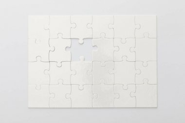 top view of completed jigsaw puzzle without one piece on white background clipart
