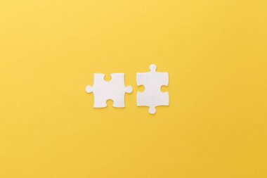 top view of white puzzle pieces on yellow background clipart