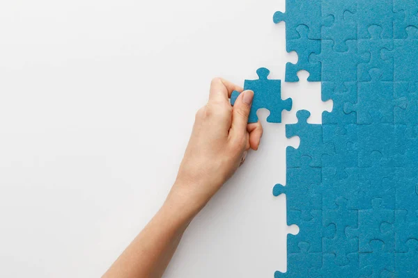 Cropped View Woman Attaching Blue Jigsaw Puzzle White Background — Stock Photo, Image