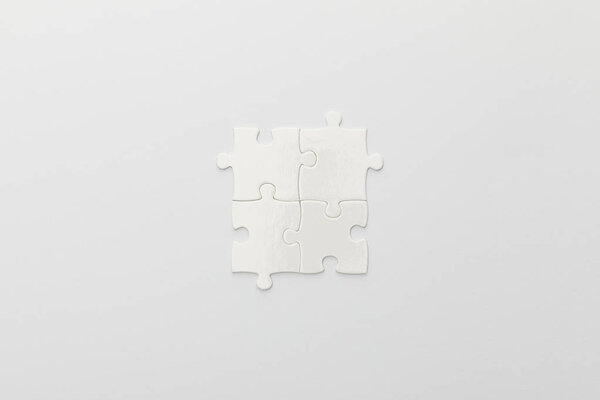 top view of completed part of jigsaw puzzle on white background