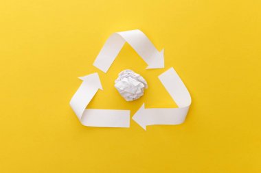 top view of white triangle with crumpled paper on yellow background clipart