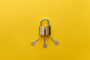 top view of metal padlock with keys on yellow background clipart