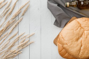 beyaz ahşap yüzeyüzerinde sivri ve yağ yakın havlu üzerinde lavaş ekmek üst görünümü