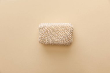 top view of natural bath sponge on beige background clipart