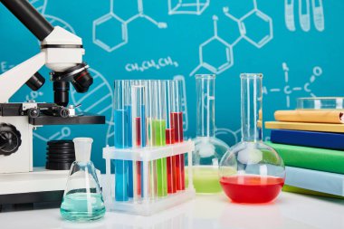 microscope, books, glass test tubes and flasks with colorful liquid on blue background with molecular structure clipart