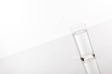 clear fresh water in glass isolated on white clipart