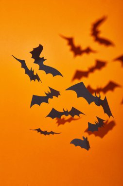 paper bats with shadow on orange background, Halloween decoration clipart