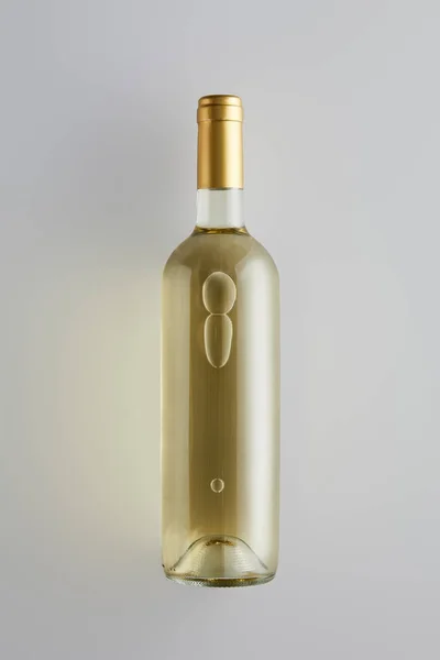top view of bottle with white wine on white background