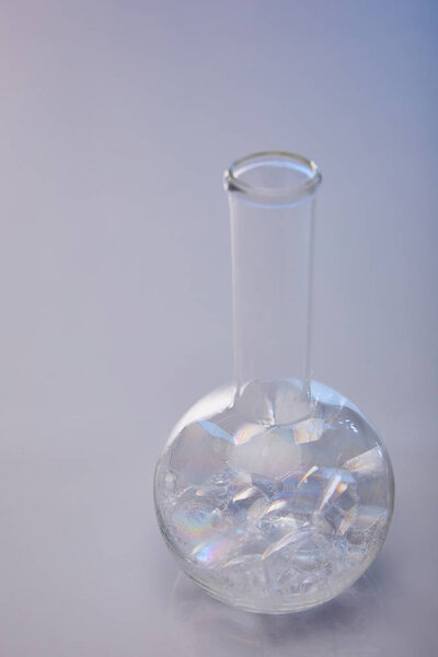 glass flask with bubbles on grey background