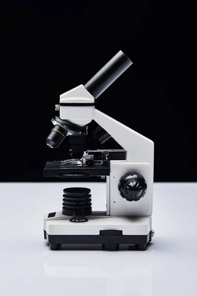 現代の顕微鏡では黒いテーブルの上に — ストック写真