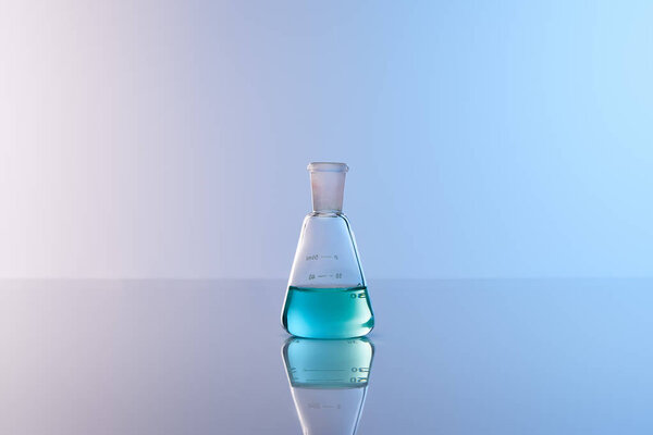 стеклянная колба с голубой красочной жидкостью
