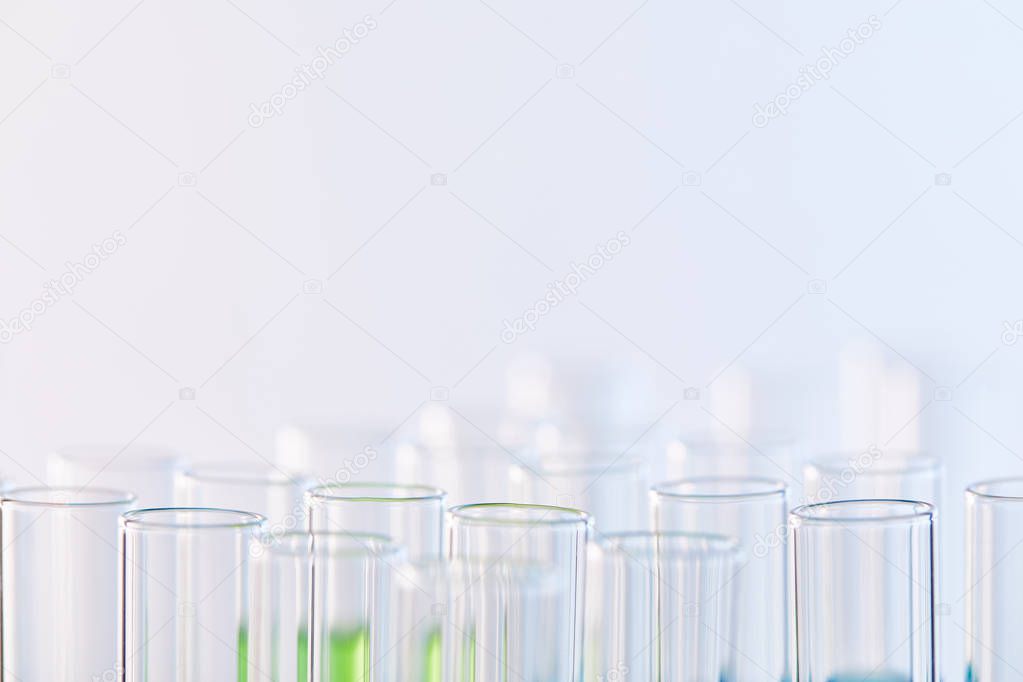 selective focus of glass test tubes with samples isolated on white
