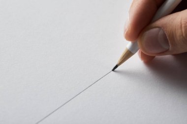 cropped view of man drawing line on paper with pencil  clipart