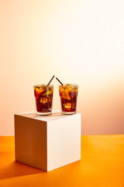 cocktails cuba libre in glasses with straws on cube   clipart