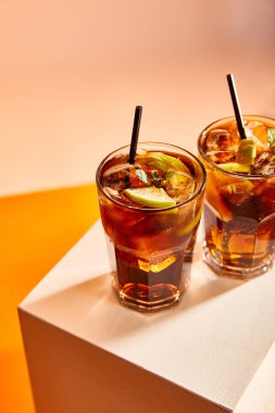 high angle view of cocktails cuba libre in glasses with straws on cube   clipart