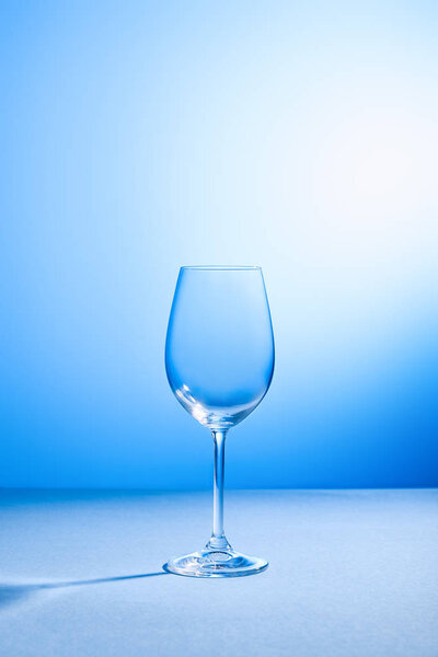 empty, clean and fragile glass on blue background with copy space