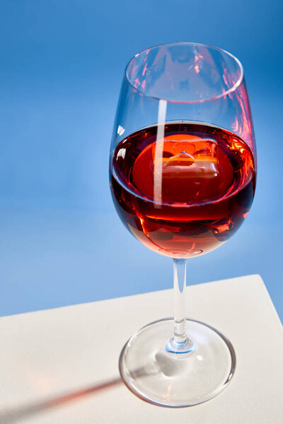 high angle view of cocktail Aperol Spritz in glass on blue background 