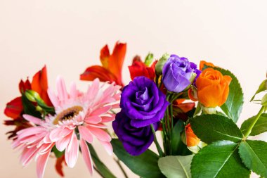 floral composition with bouquet of colorful flowers isolated on beige, selective focus clipart