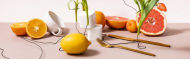 floral and fruit composition with flowers, fruits, cutlery, cup isolated on beige, panoramic crop clipart