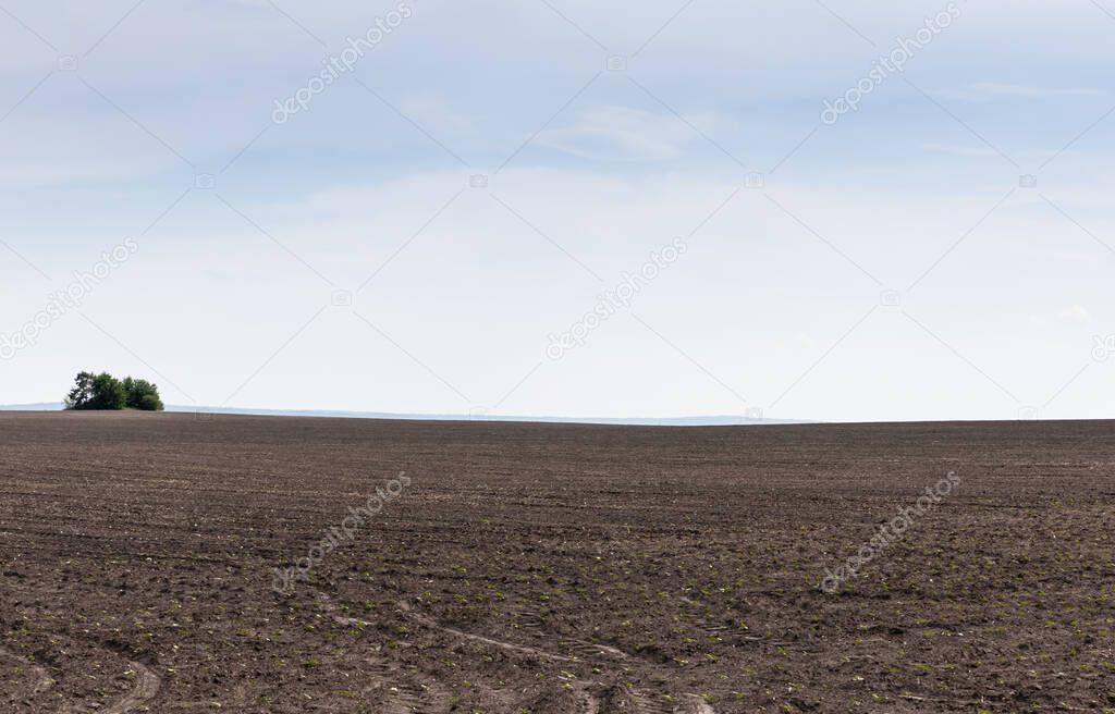 land with ground against blue sky and clouds 