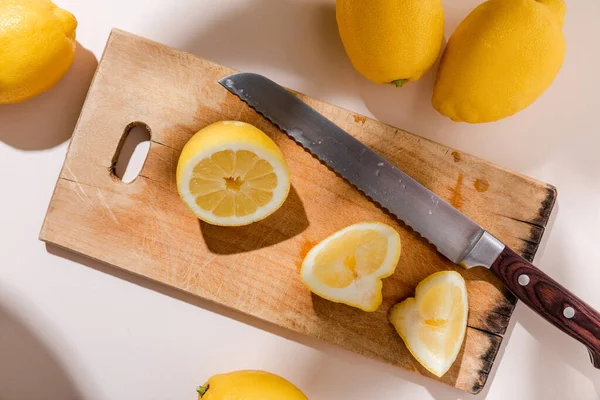 Ovanifrån Hela Och Skurna Citroner Träskiva Med Kniv Grått Bord — Stockfoto