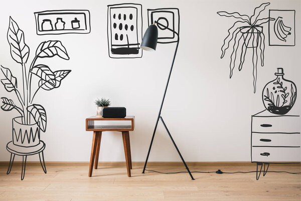floor lamp, wooden coffee table and clock with blank screen near drawn plants, paintings and dresser 