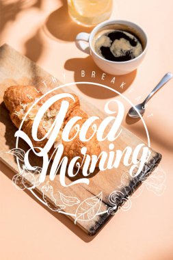 fresh croissants on wooden board and cup of coffee for breakfast on beige table with healthy breakfast, good morning lettering clipart