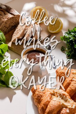 fresh croissants, bread, greenery and cup of coffee for breakfast on grey table with coffee makes everything okayer lettering clipart