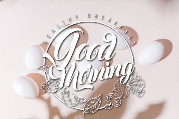 top view of white boiled chicken eggs on grey table with healthy breakfast, good morning lettering  