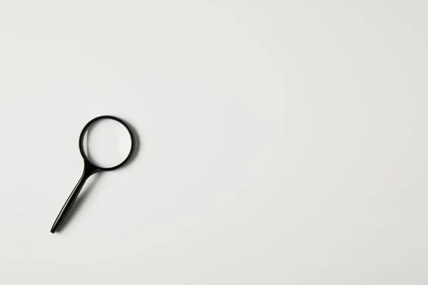 Top view of single magnifying glass with handle isolated on grey — Stock Photo