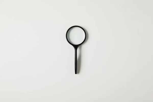 Top view of single black magnifying glass with handle isolated on grey — Stock Photo