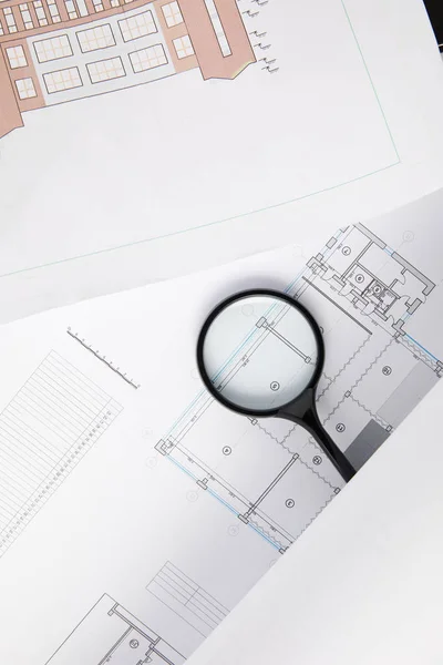Top view of magnifying glass and blueprints, architecture concept — Stock Photo