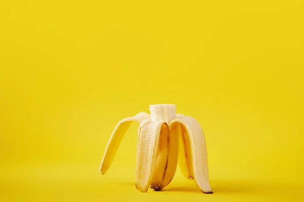 Close up view of ripe cut banana isolated on yellow — Stock Photo