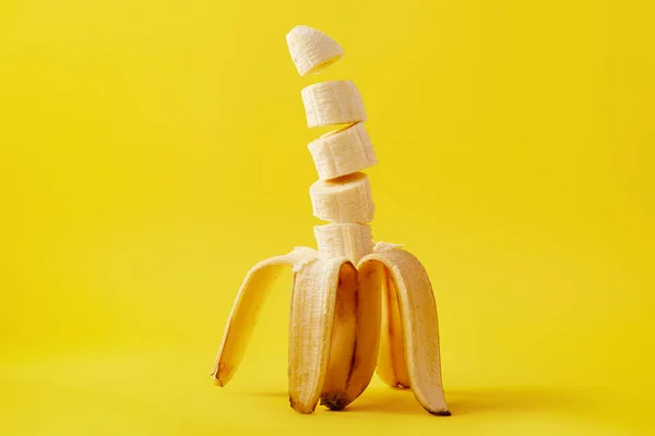 Close up view of ripe cut banana isolated on yellow — Stock Photo