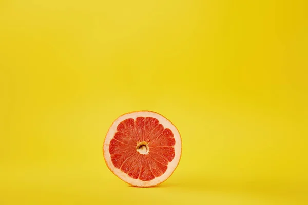 Close up view of fresh ripe grapefruit isolated on yellow — Stock Photo