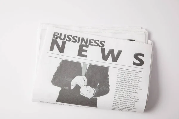 One business newspaper lying on white background — Stock Photo