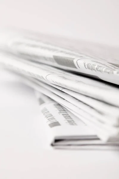 Close up of pile of daily newspapers, selective focus on white — Stock Photo