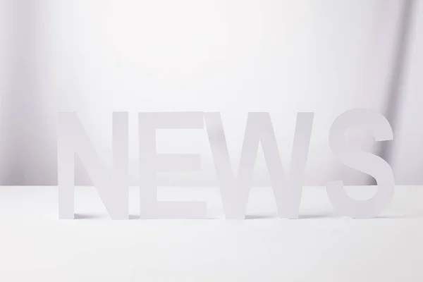 Minimalistic word news made of paper, on white background — Stock Photo